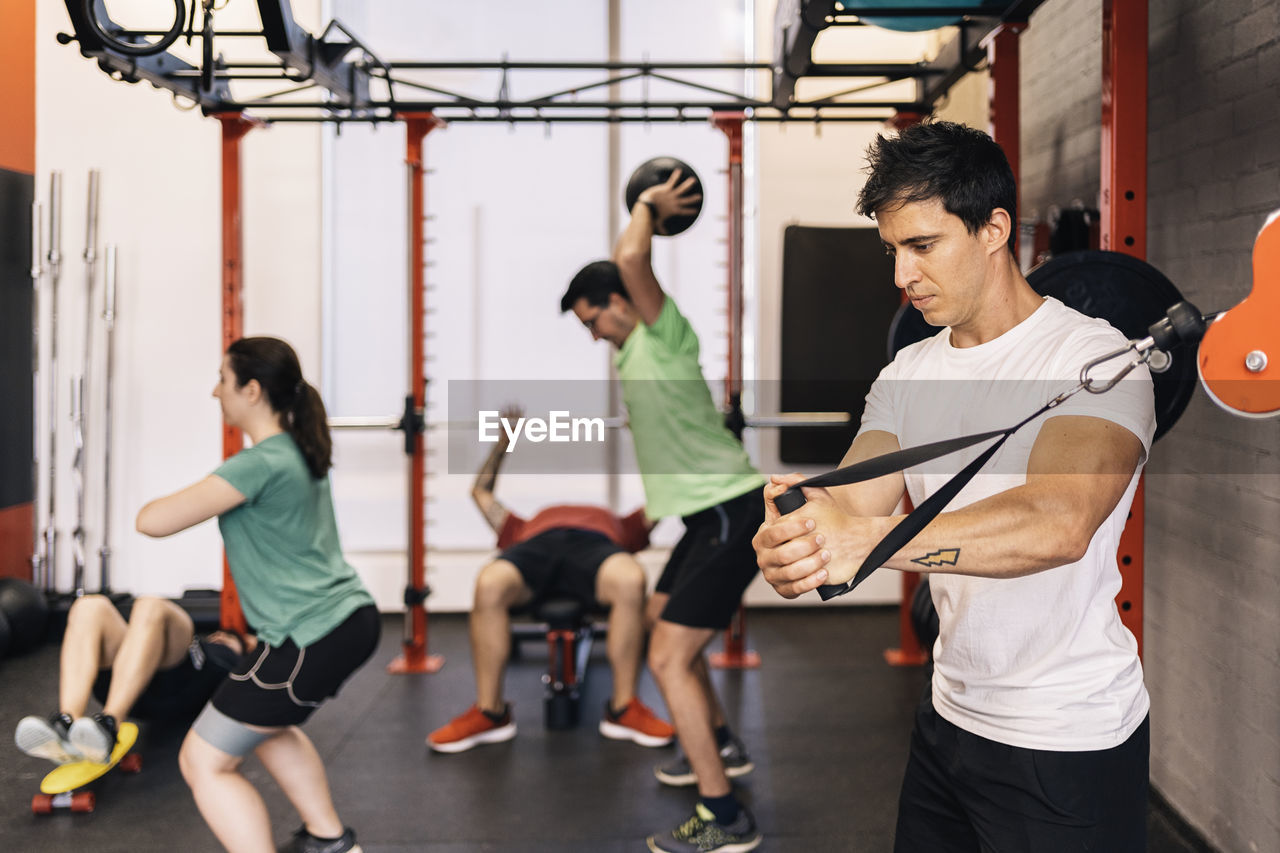 Group of beginners athletes exercising in a personal class with a private trainer. various exercises