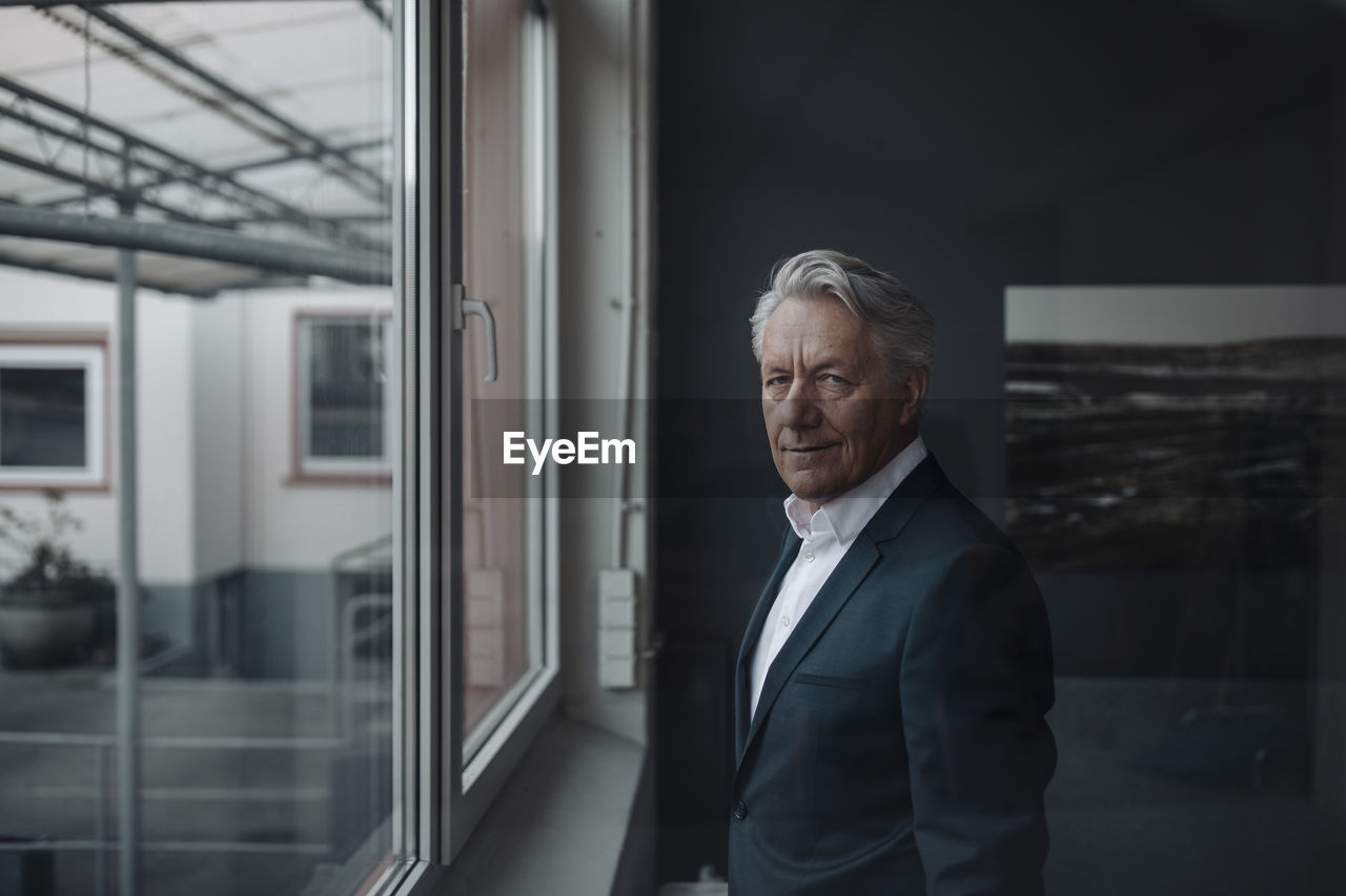 Portrait of a senior businessman at the window