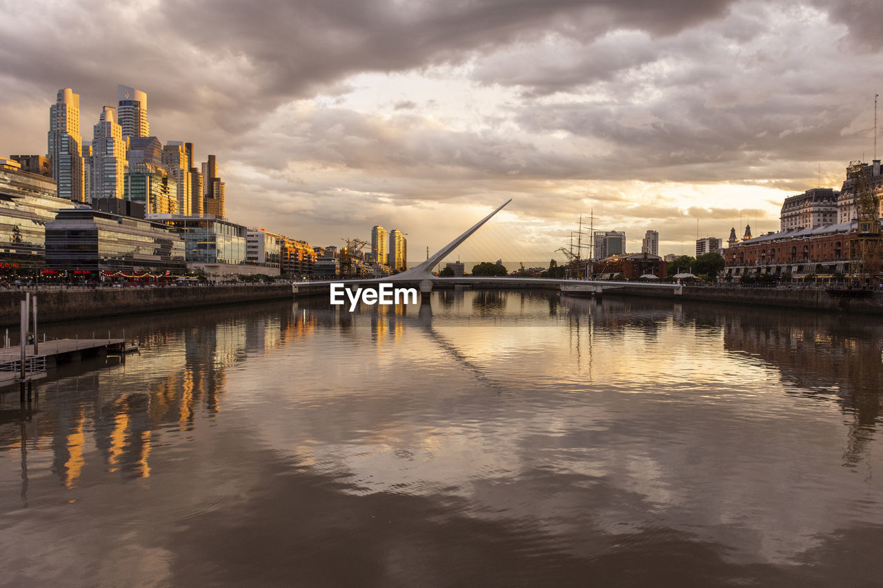 Beautiful sunset view to modern bridge and buildings in puerto madero