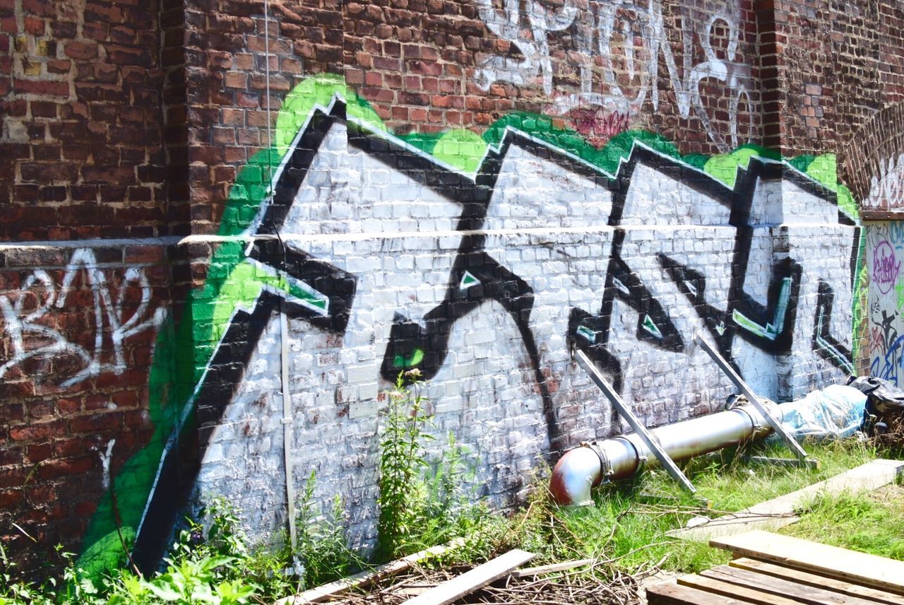 Close-up of graffiti on brick wall