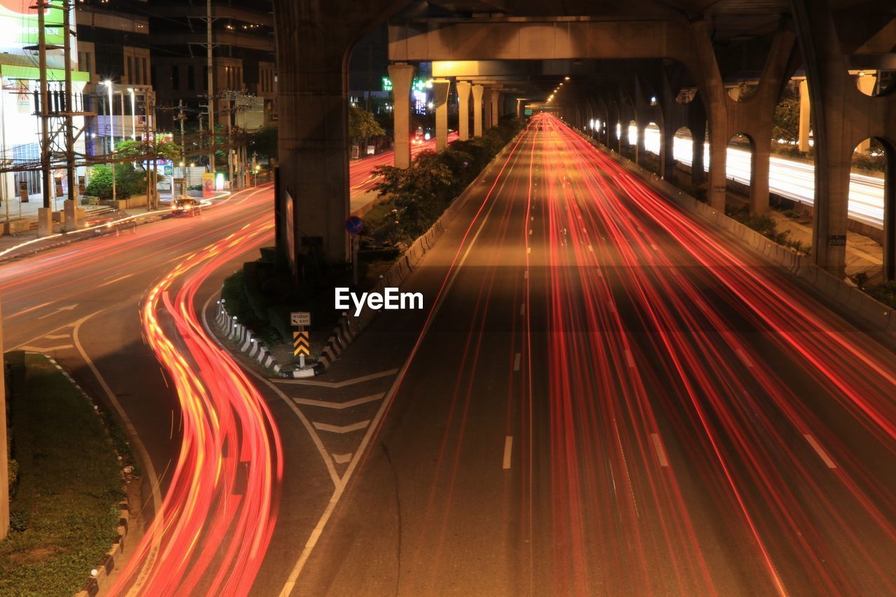 LIGHT TRAILS ON ROAD IN CITY