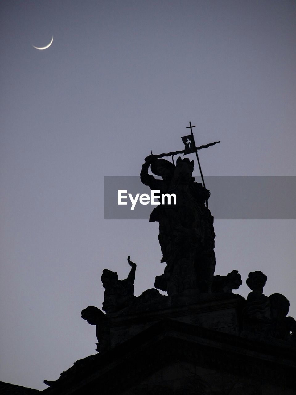 Low angle view of silhouette statue against clear sky