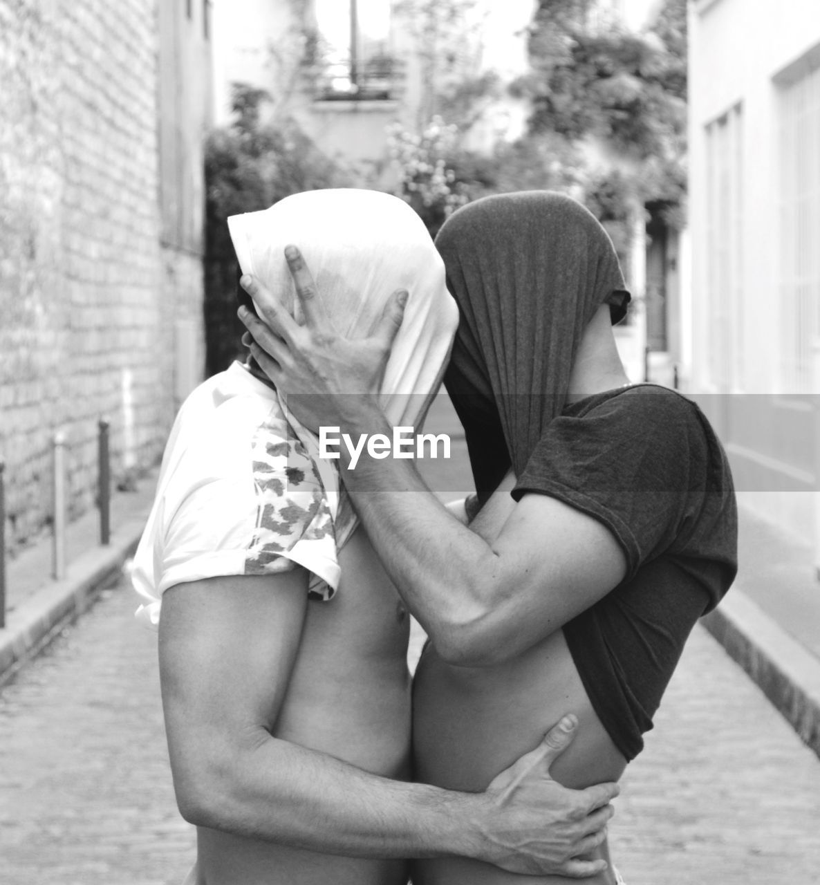 Gay couple embracing on street