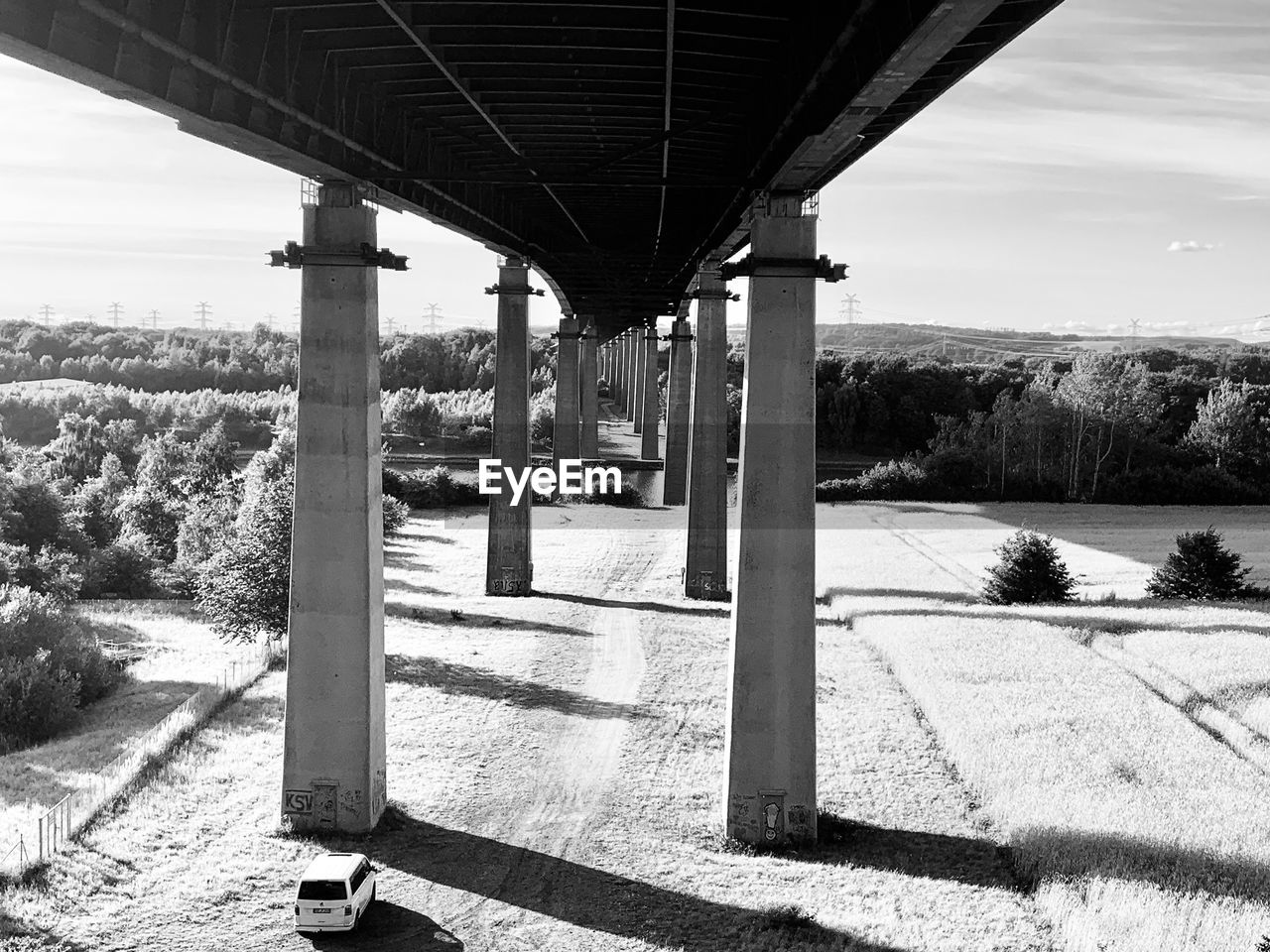 View underneath bridge and pillars against sky