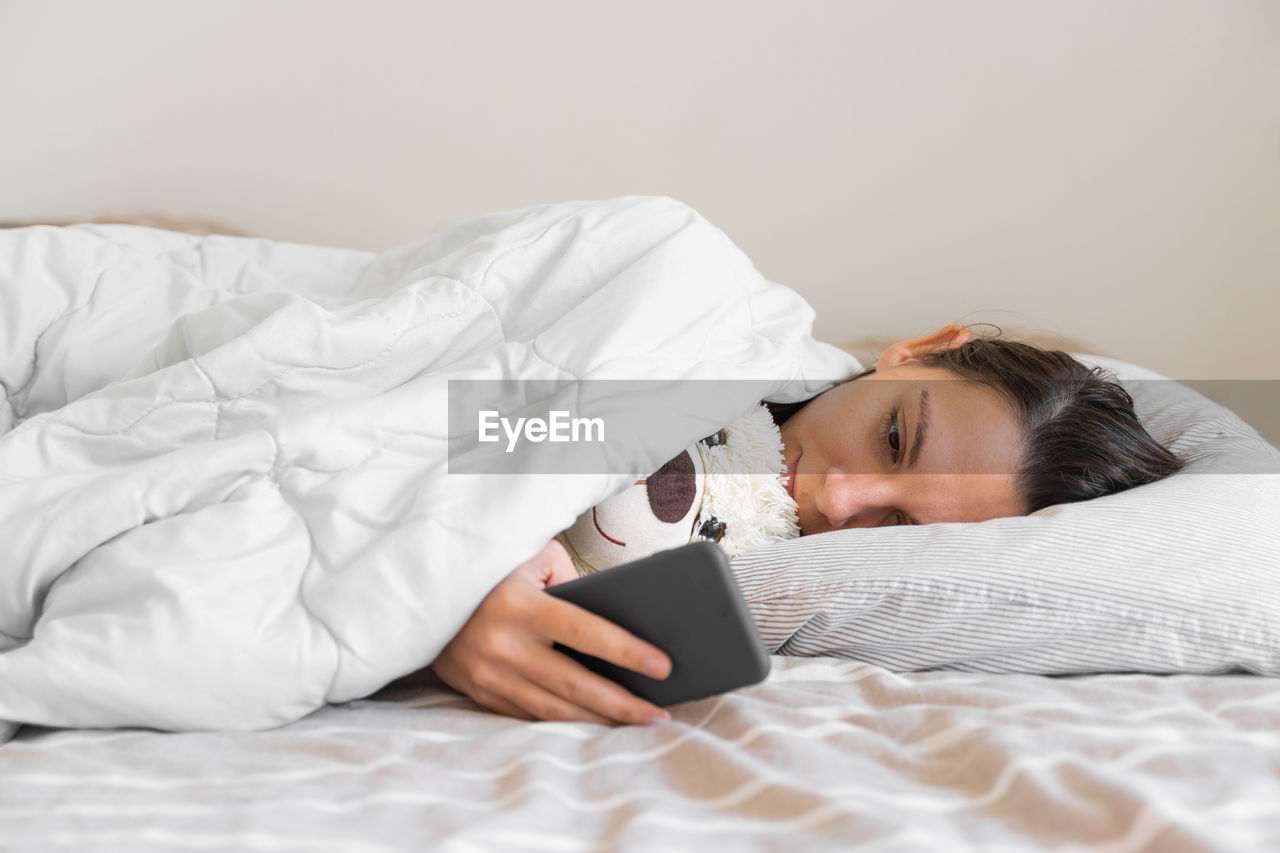 Young woman sleeping on bed at home