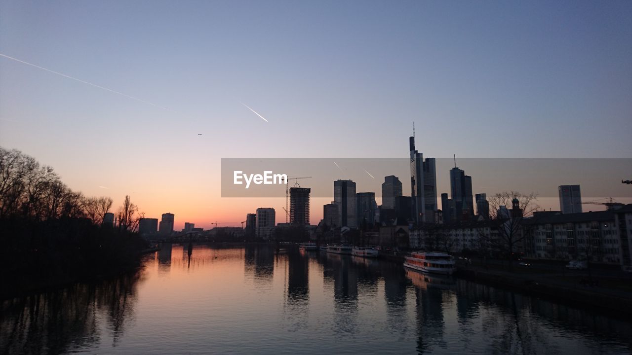 View of city at waterfront during sunset