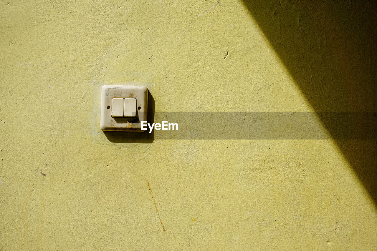 High angle view of light switch on wall