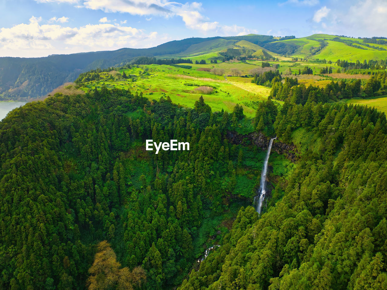 environment, landscape, land, scenics - nature, plant, green, beauty in nature, mountain, tree, nature, rural scene, sky, mountain range, forest, field, agriculture, cloud, tranquility, no people, travel, environmental conservation, valley, foliage, lush foliage, ridge, tranquil scene, non-urban scene, social issues, outdoors, plateau, crop, growth, travel destinations, wilderness, meadow, aerial view, summer, idyllic, natural environment, day, highland, farm, rural area, tourism, high angle view, water, sunlight, woodland, leaf, aerial photography