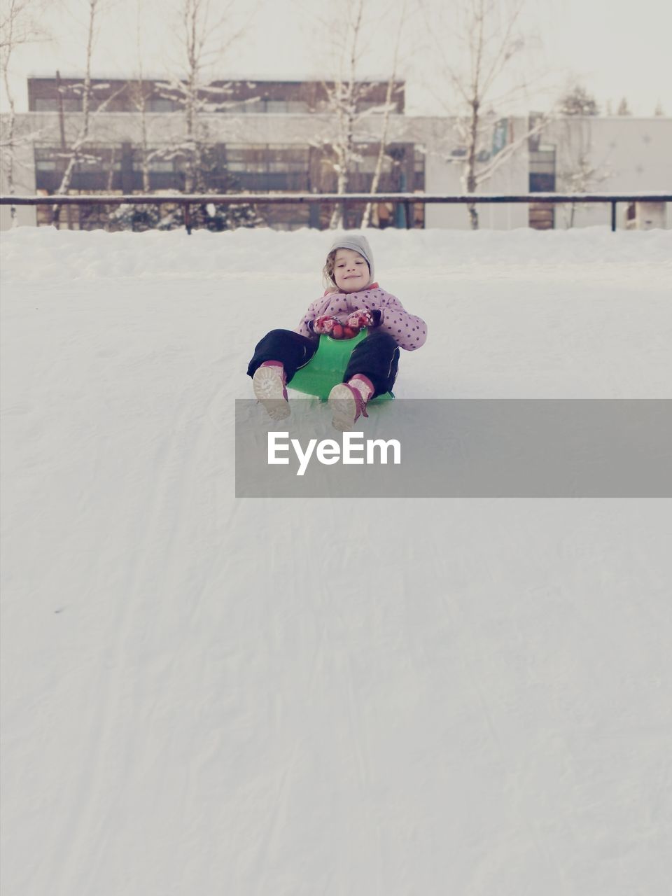 Girl playing on snow covered field
