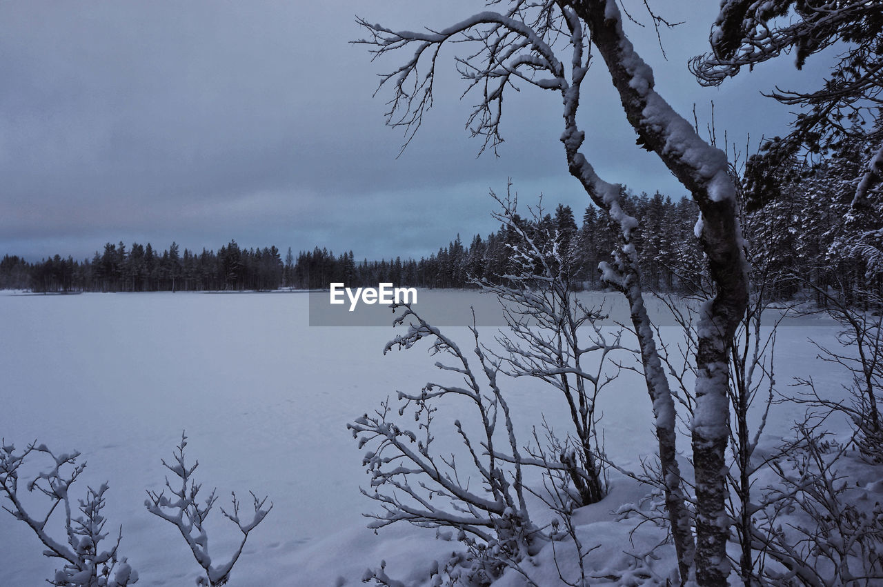 FROZEN LAKE AGAINST SKY DURING WINTER