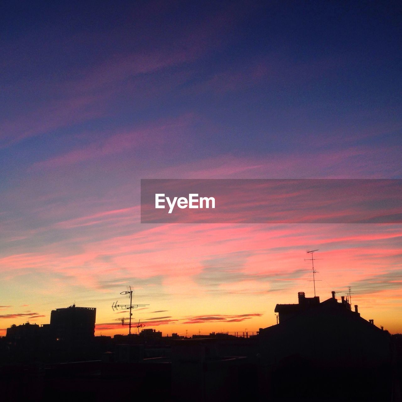 Silhouette of buildings against dramatic sky