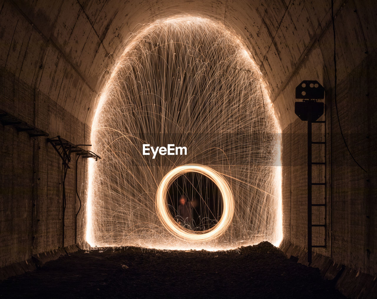 Illuminated wire wool in tunnel at night