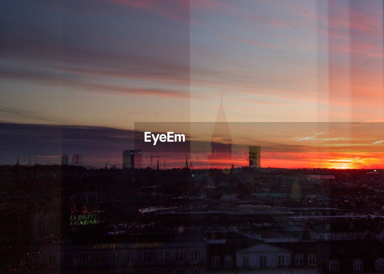 Silhouette buildings against sky during sunset