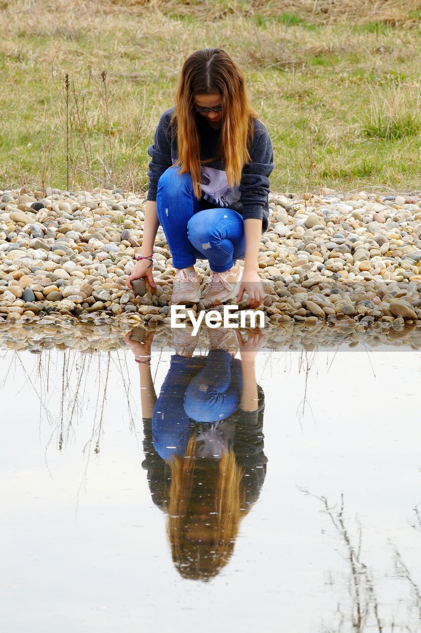 Reflection of girl in lake