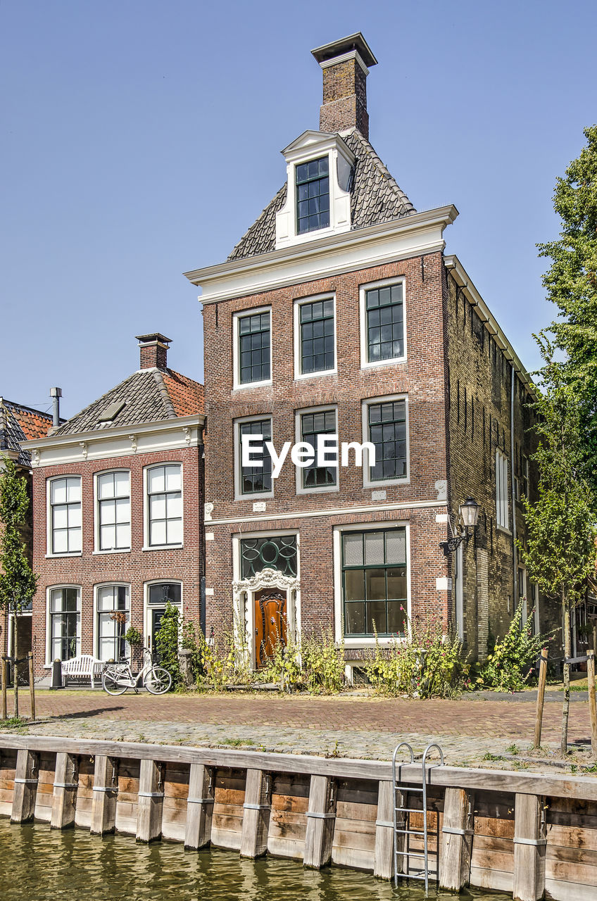 Traditional brick houses next to a dutch canal