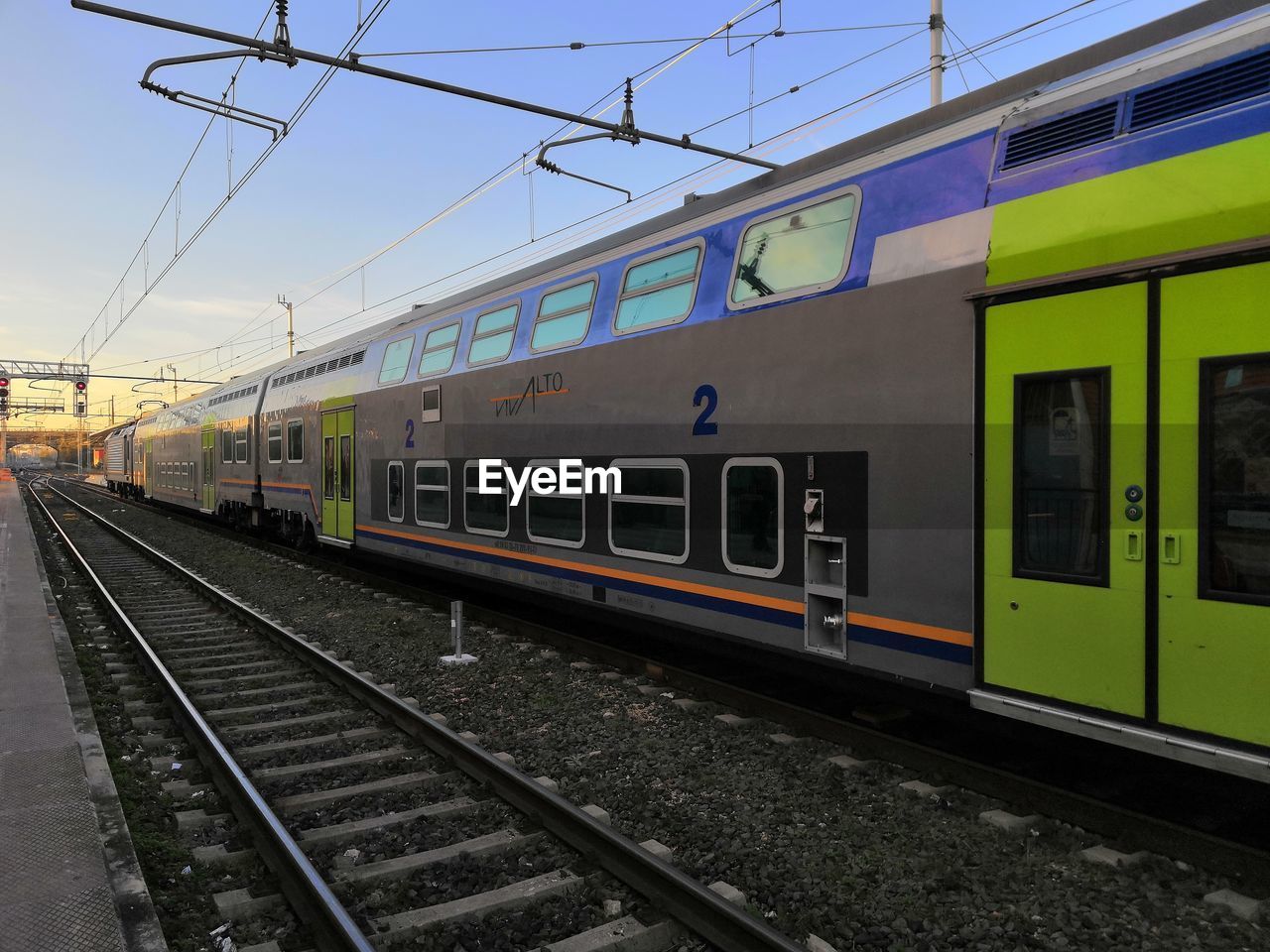 TRAIN ON RAILROAD STATION PLATFORM