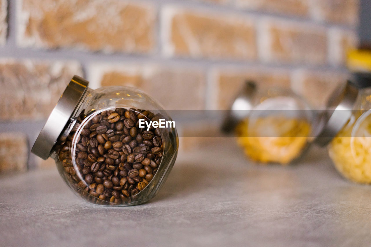 Glass jar with roasted coffee in the kitchen or bar