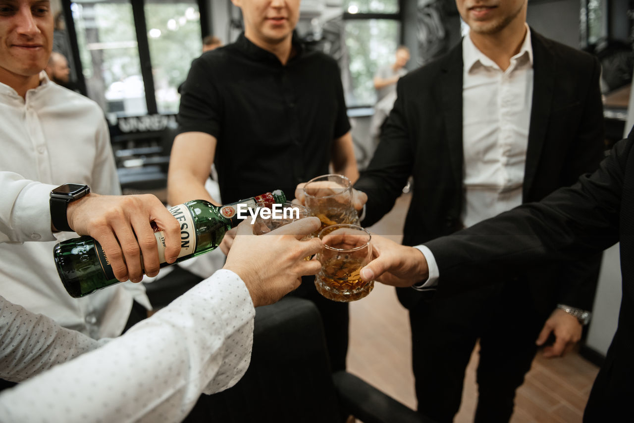 group of people, adult, men, business, women, food and drink, mature adult, clothing, person, indoors, food, female, young adult, togetherness, holding, celebration, drink, businessman, refreshment, smiling, emotion, happiness, communication, friendship, meal, business finance and industry, alcohol