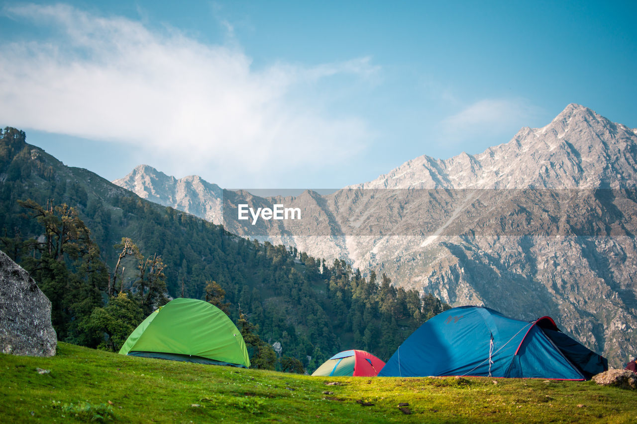 TENT ON MOUNTAIN AGAINST SKY