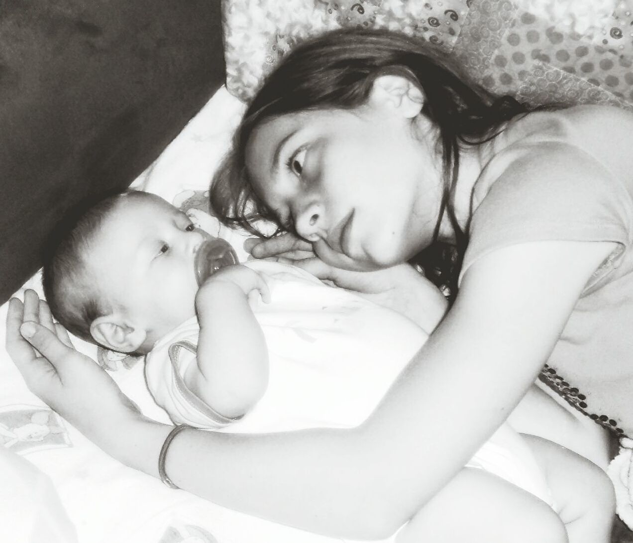 Portrait of cute girl looking at baby 