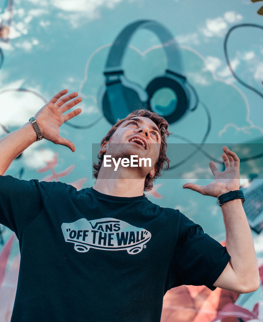 PORTRAIT OF YOUNG MAN WITH TEXT IN BACKGROUND