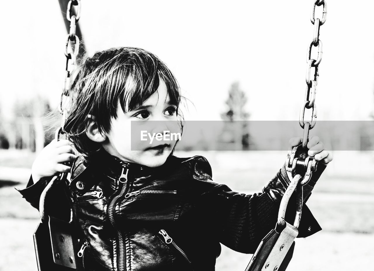 Girl sitting on swing