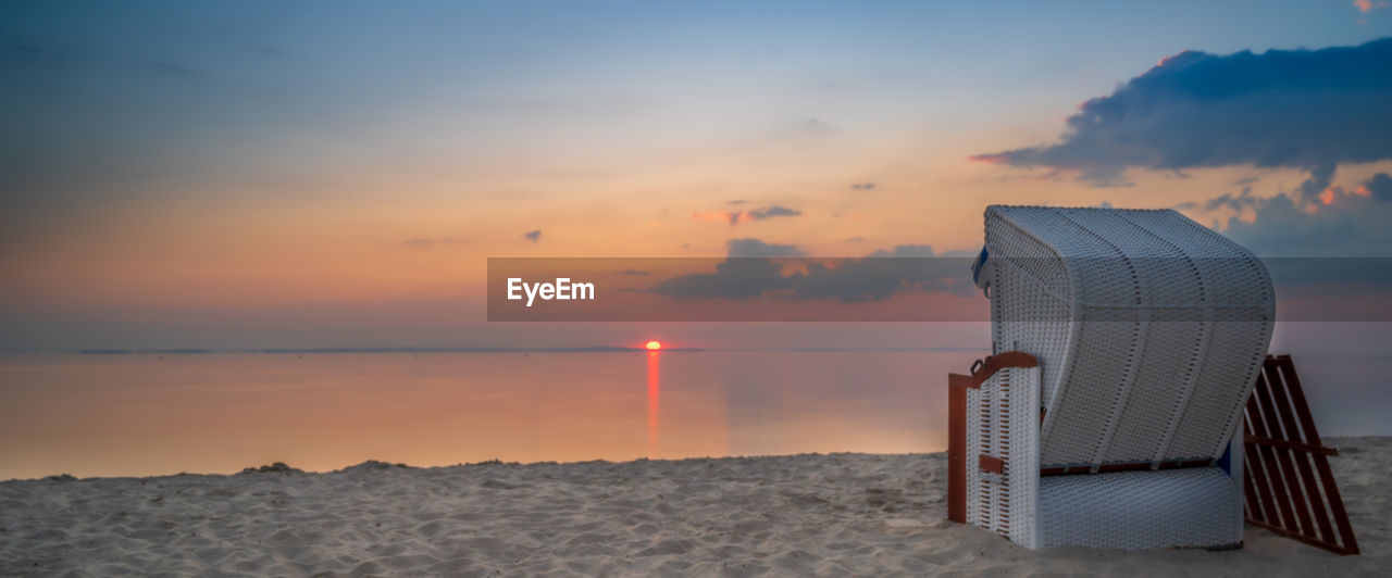 SCENIC VIEW OF BEACH AT SUNSET