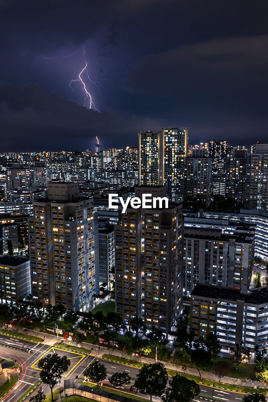 Illuminated cityscape against sky at night