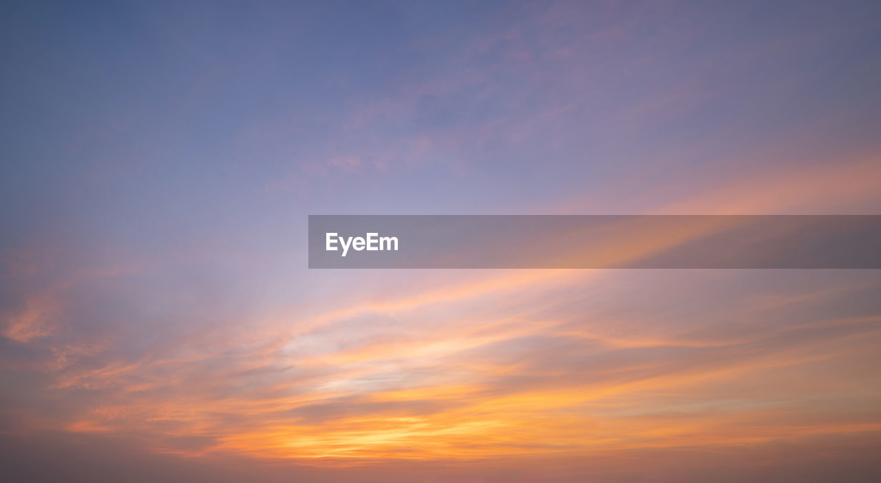 sky, sunset, cloud, beauty in nature, afterglow, scenics - nature, red sky at morning, tranquility, dramatic sky, nature, tranquil scene, idyllic, orange color, horizon, cloudscape, no people, environment, backgrounds, dawn, sunlight, outdoors, atmosphere, evening, twilight, copy space, sun, moody sky, multi colored, awe, atmospheric mood, urban skyline, blue, vibrant color, silhouette