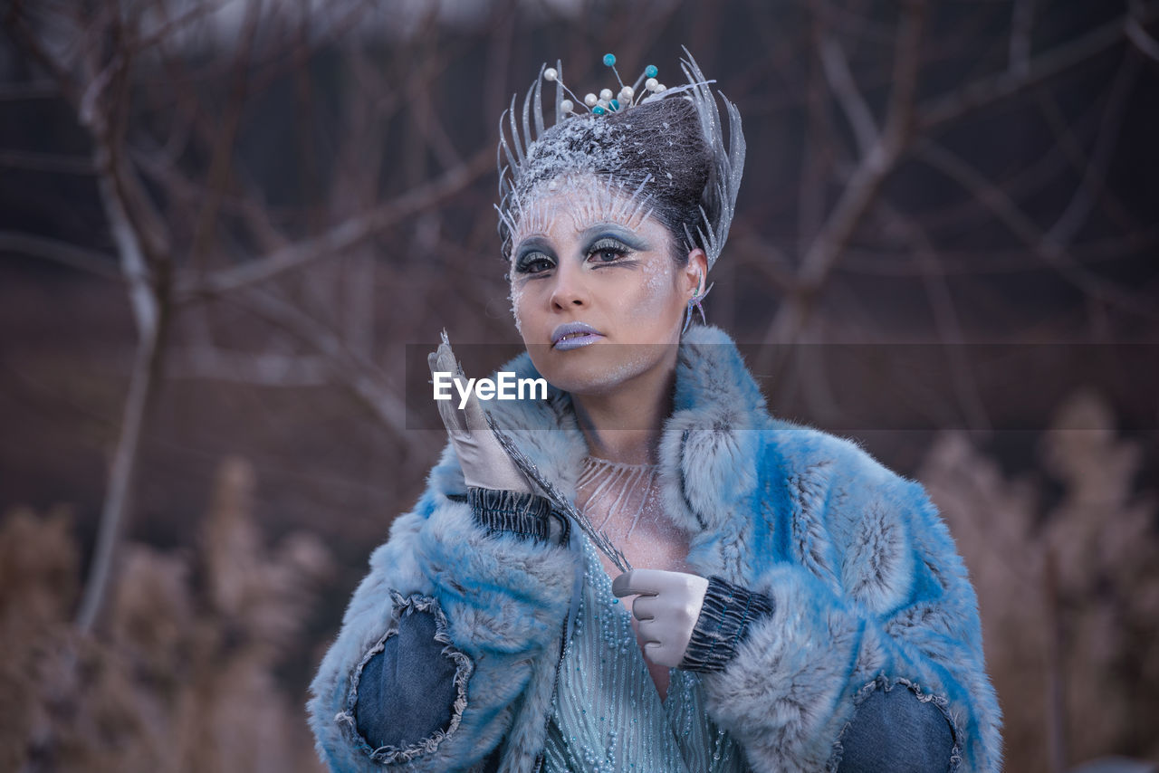 Portrait of woman wearing mask standing in winter