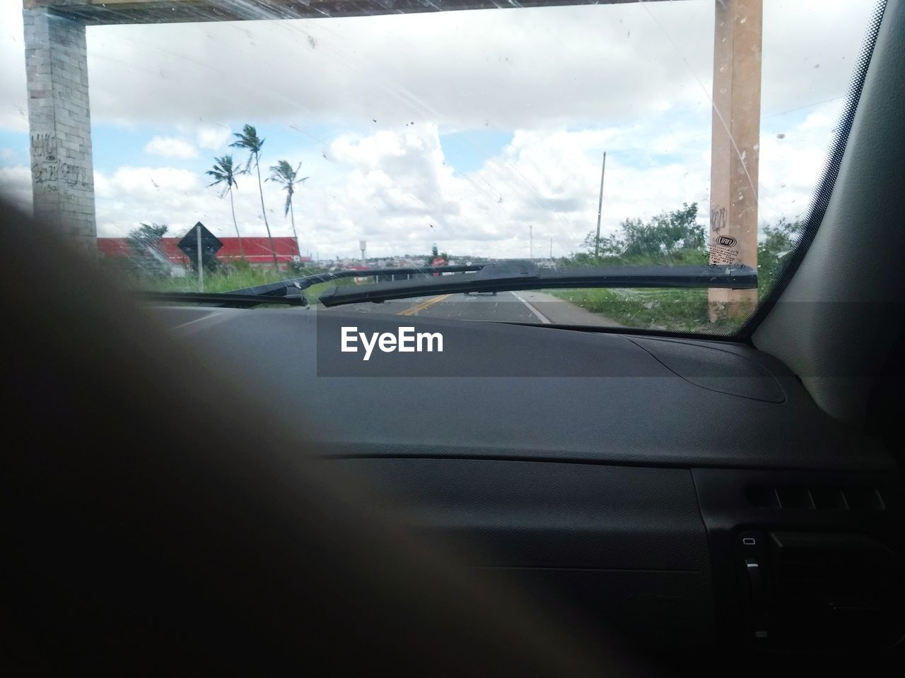 ROAD SEEN THROUGH CAR WINDSHIELD