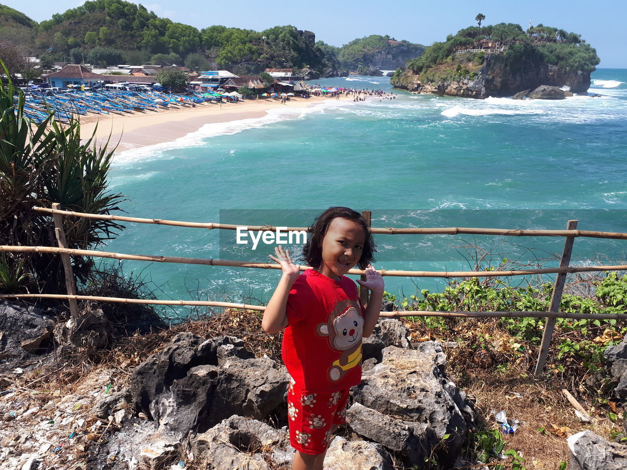 Portrait of smiling girl standing on sea shore