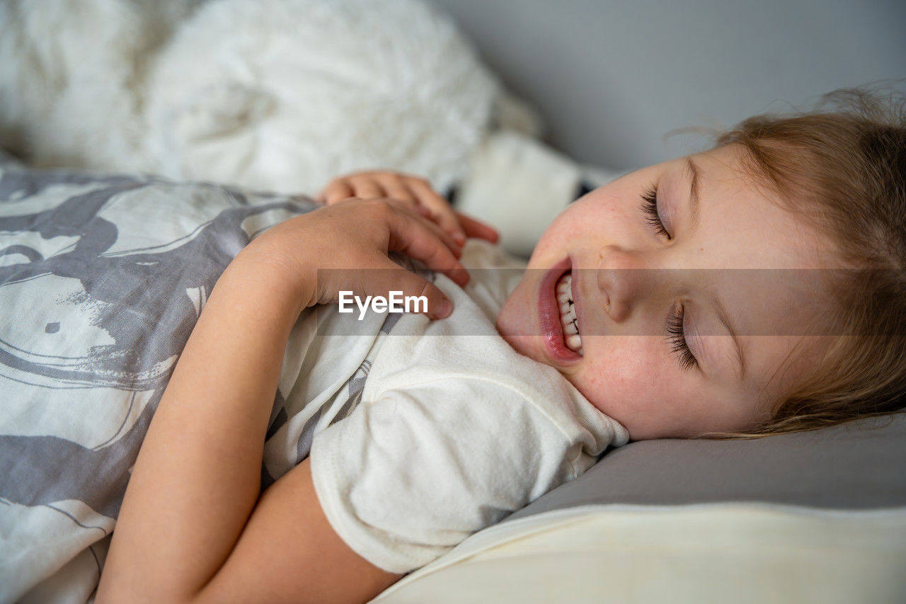 high angle view of woman sleeping on bed at home