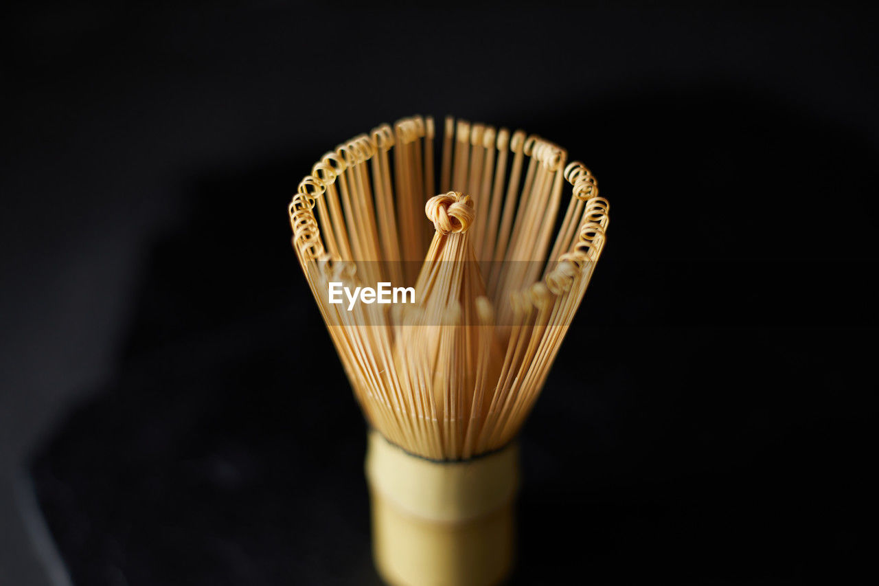 yellow, black background, macro photography, studio shot, indoors, close-up, lighting, no people, single object, brush, still life