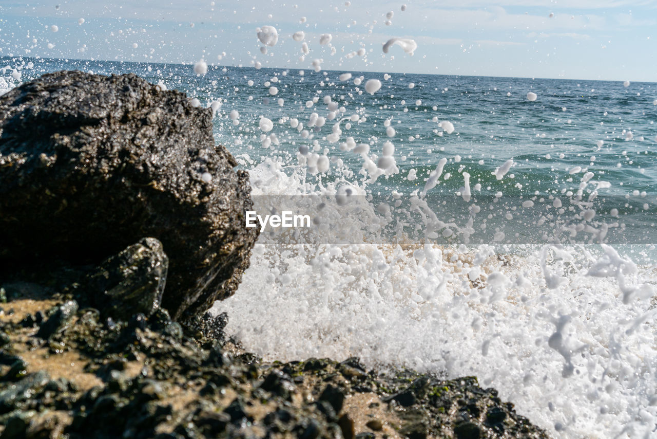 WATER SPLASHING ON ROCKS