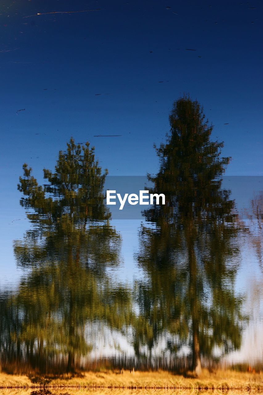 Scenic view of lake against clear blue sky