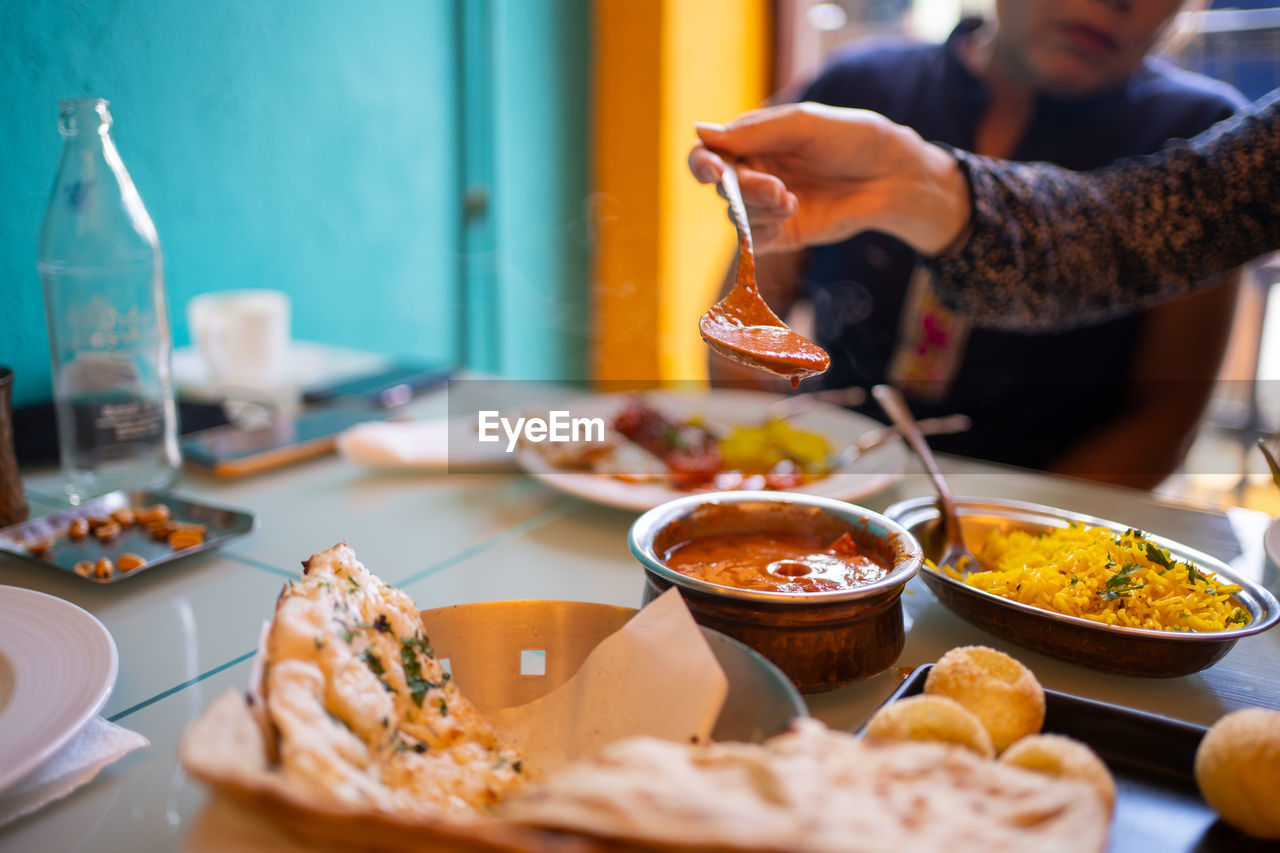 cropped hand of man preparing food