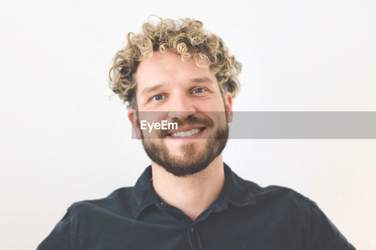 Portrait of young man against white background