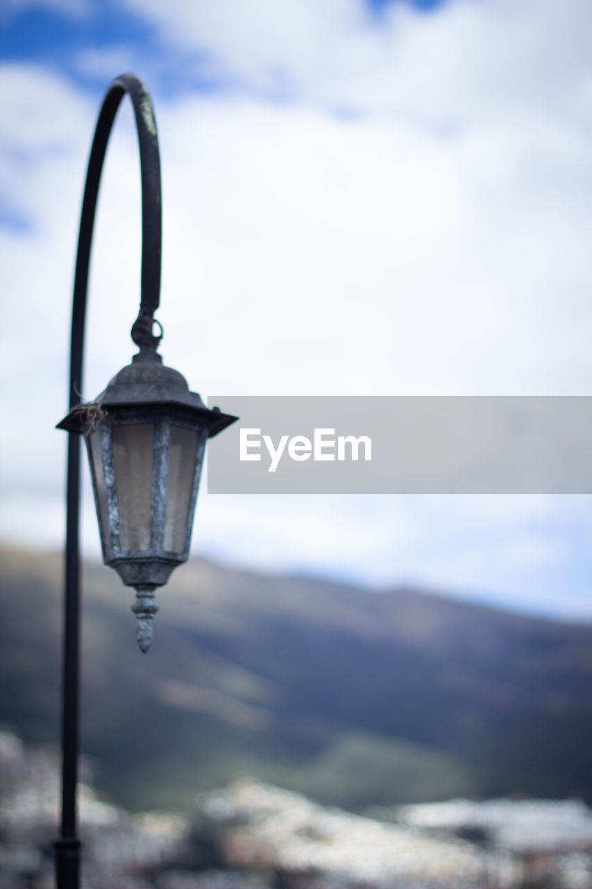 CLOSE-UP OF LAMP AGAINST SKY