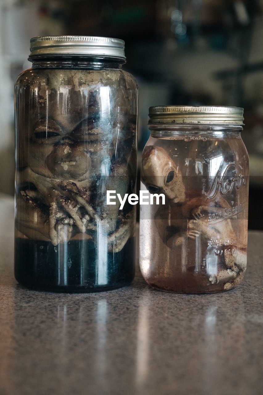 Close-up of alien in glass jar on table