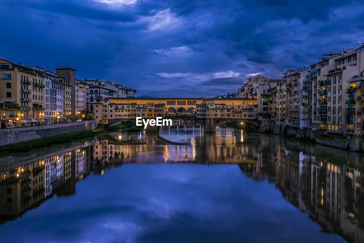 View of bridge over river at night