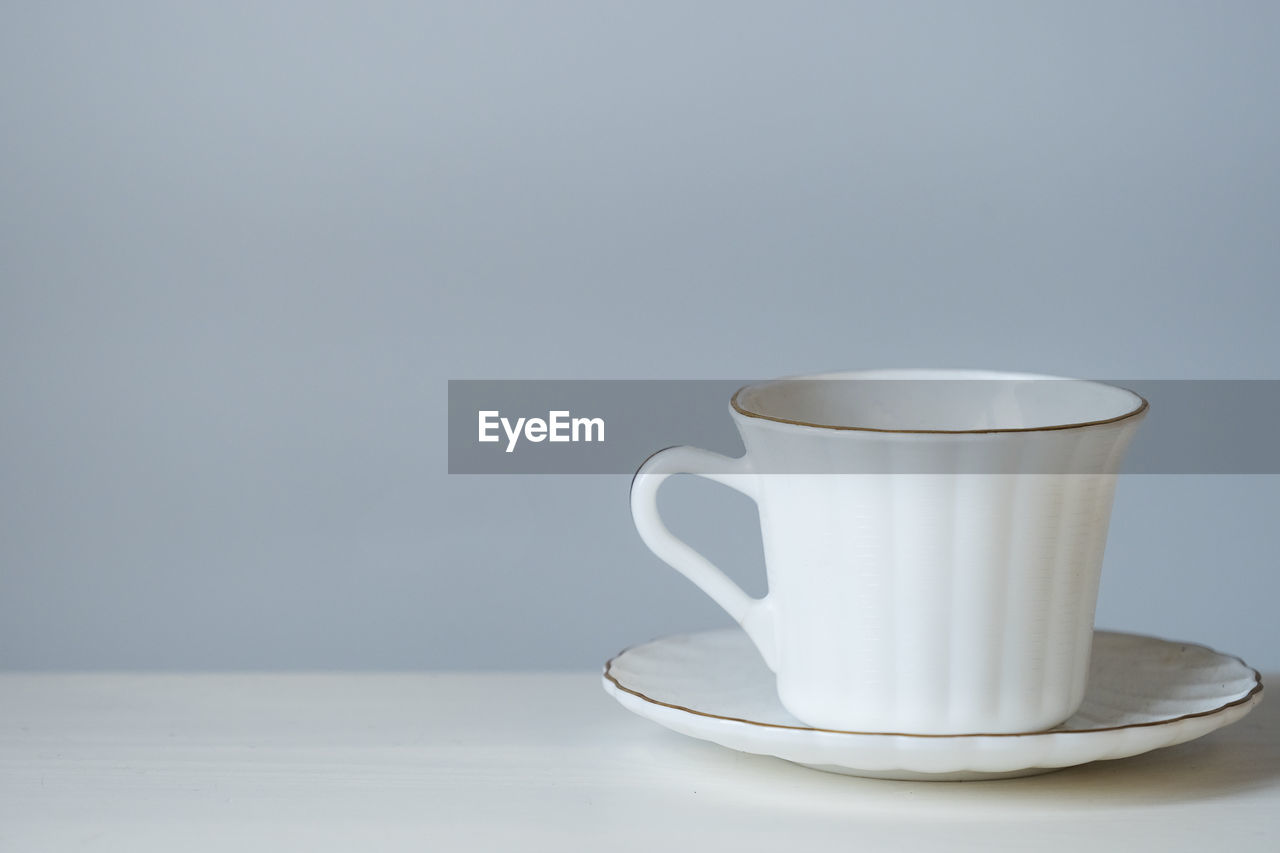 White coffee cup on the table, copy space for text
