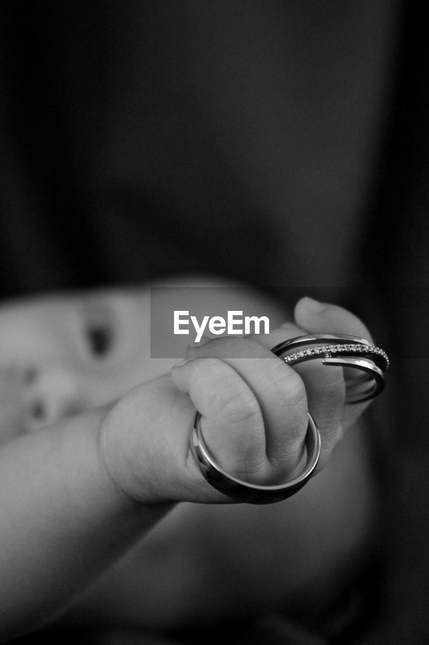 Close-up of baby holding rings