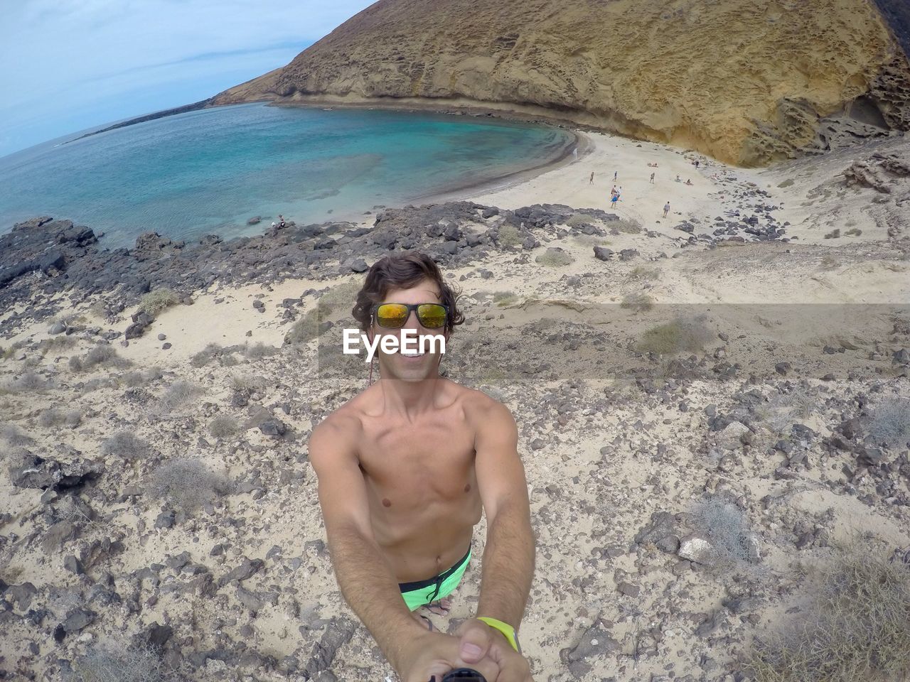 Man taking selfie with monopod at beach