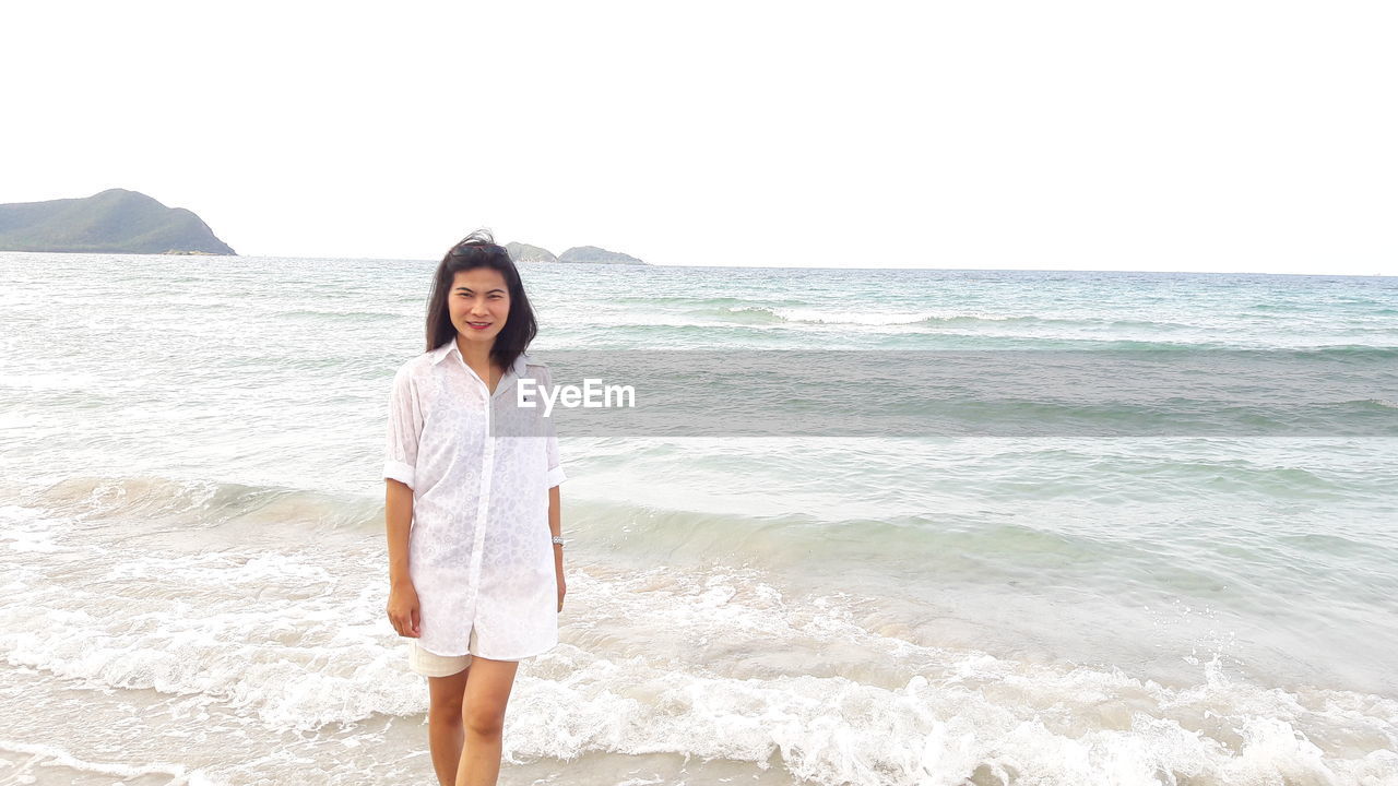 Portrait of woman standing on beach