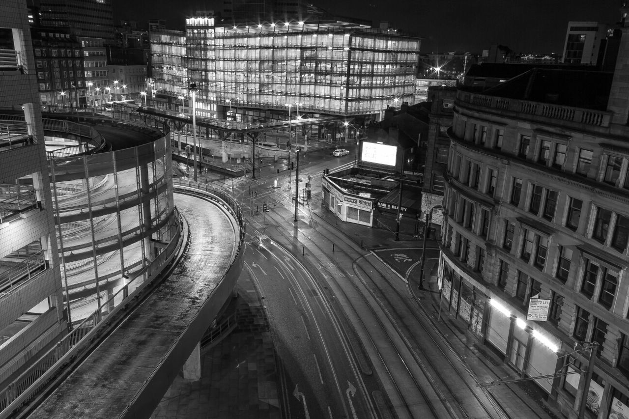 High angle view of city street and buildings at night