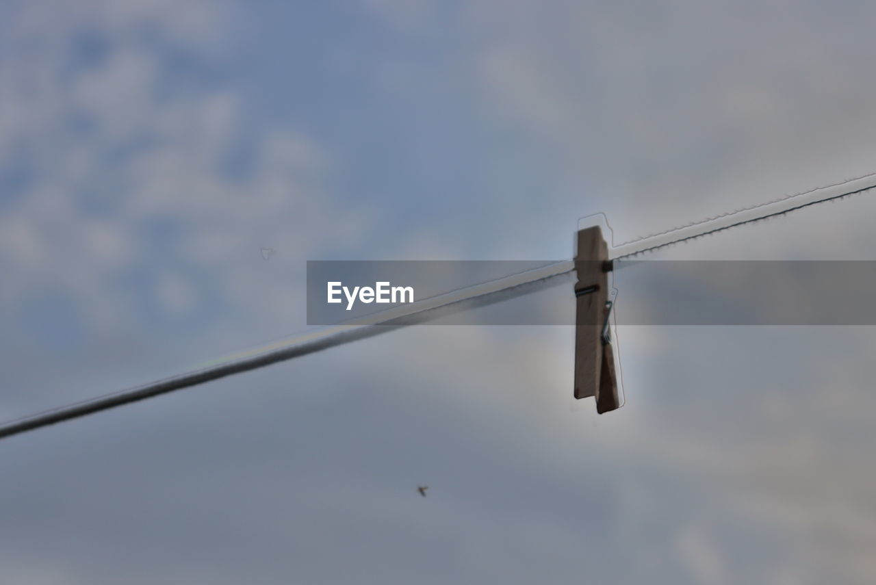 sky, no people, cloud, low angle view, nature, mast, hanging, day, wing, blue, aircraft, outdoors, line, flying, airplane, animal, animal themes, wind, bird, clothesline, street light, cable, vehicle, wildlife, rope