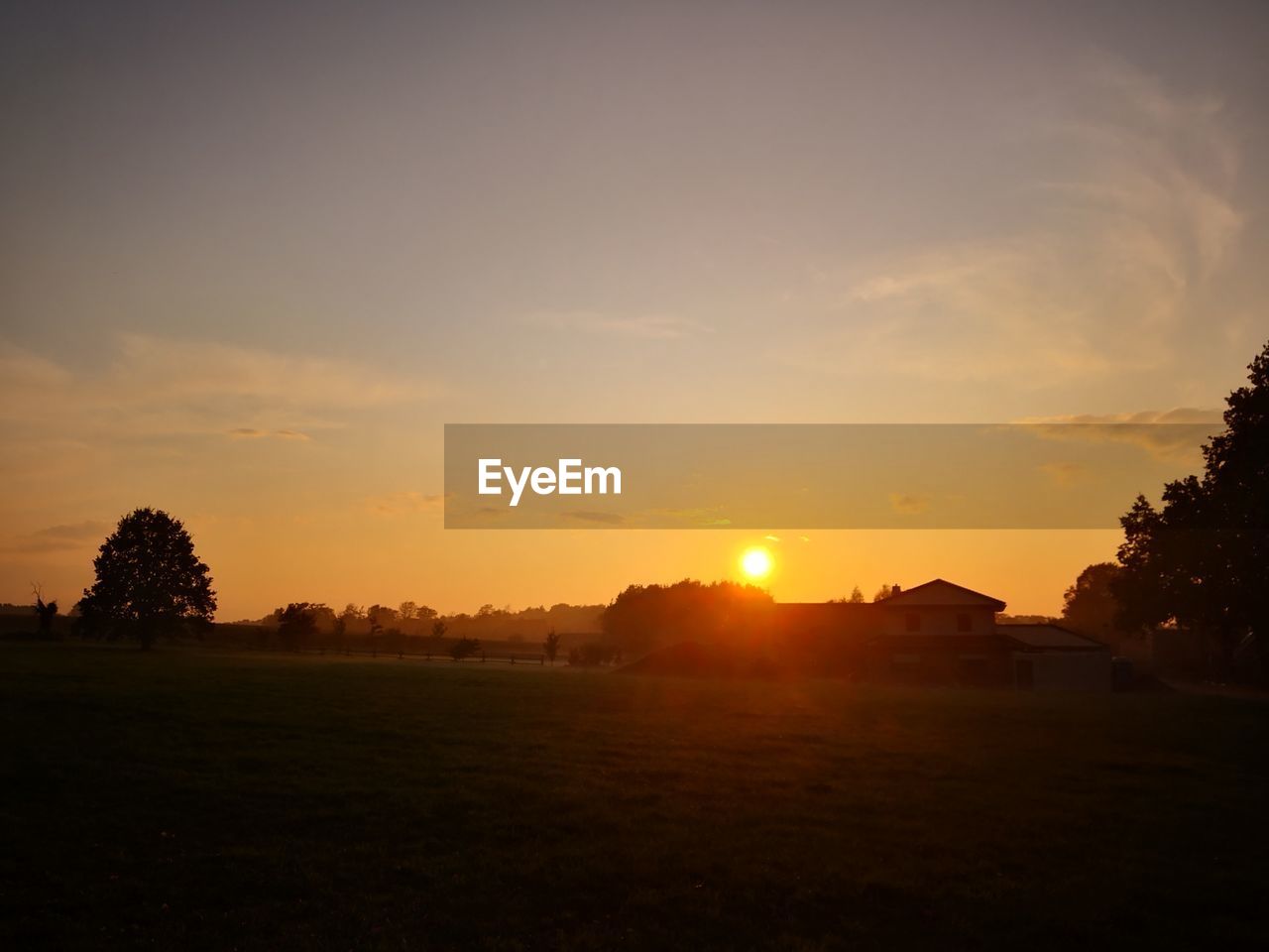 SCENIC VIEW OF SILHOUETTE FIELD AGAINST SKY DURING SUNSET