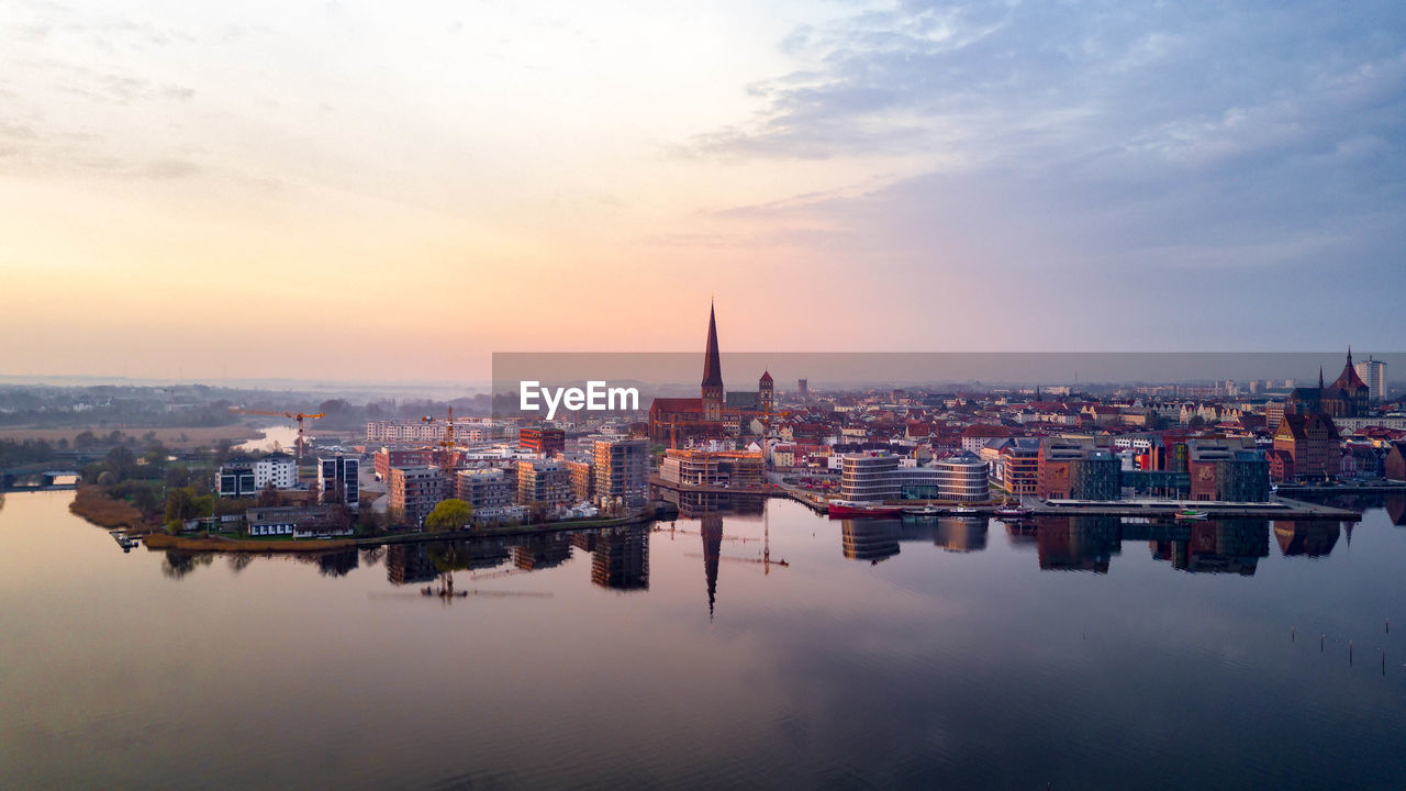 High angle view of buildings against cloudy sky during sunset