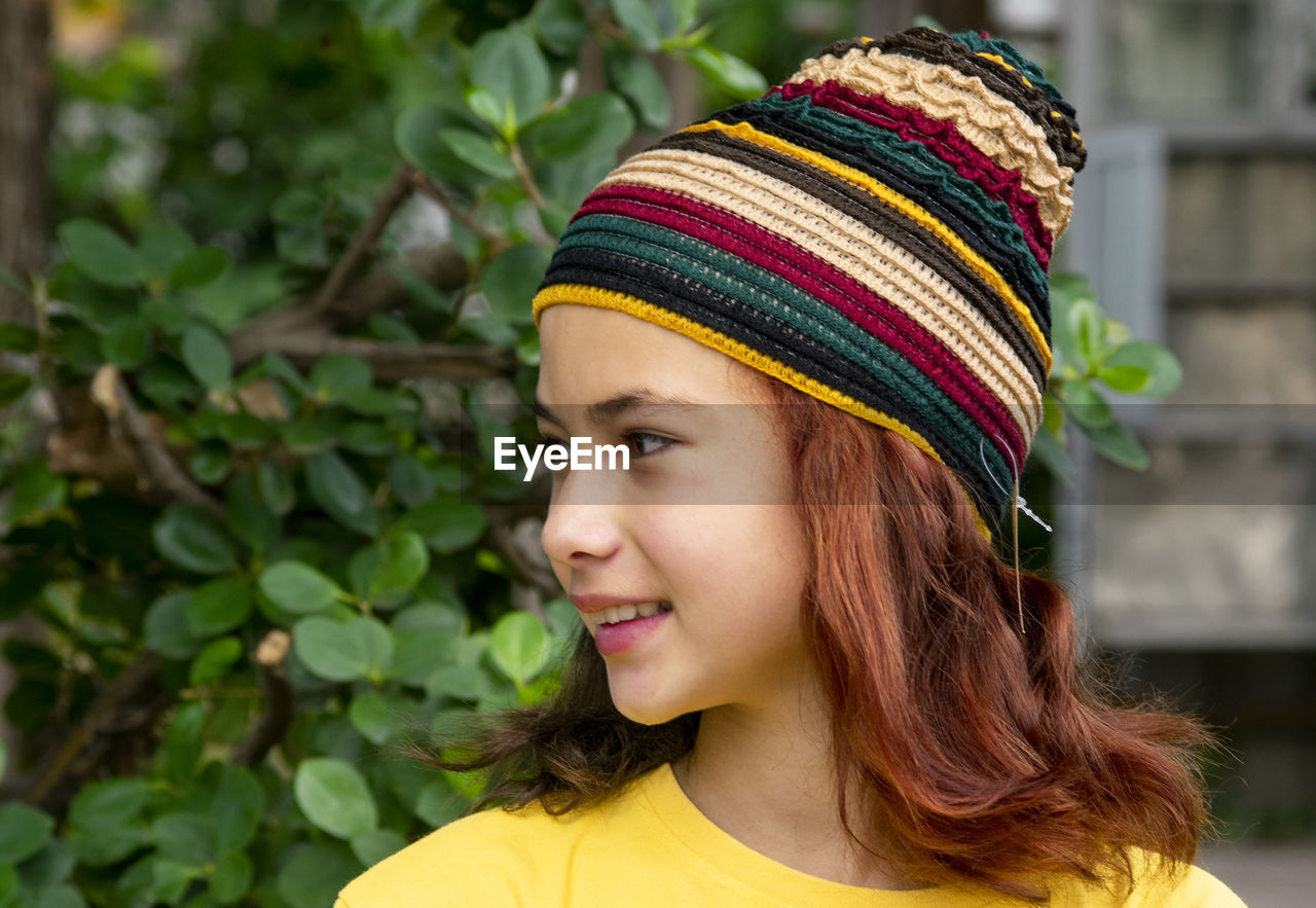 Beautiful girl model white teen  wearing a hat knitting face close-up